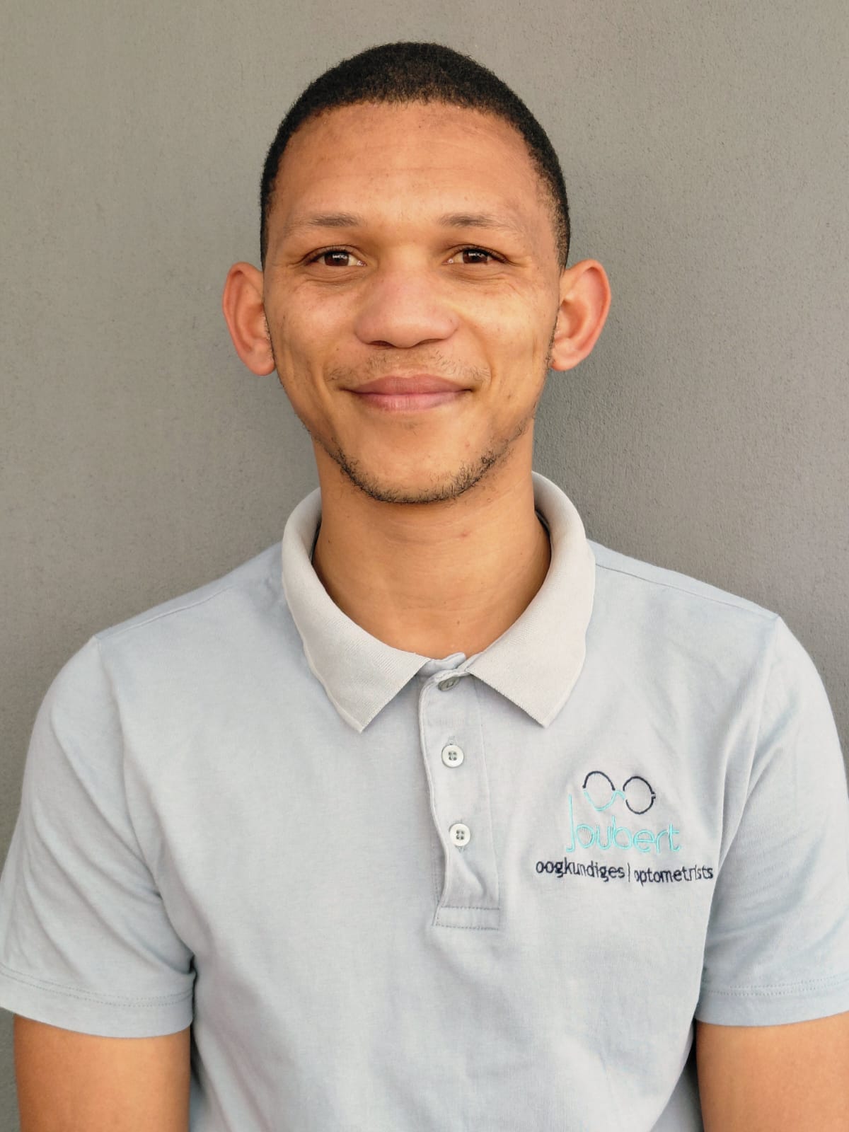 Breyten — entry level laboratory engineer at Joubert Oogkundiges in branded polo shirt